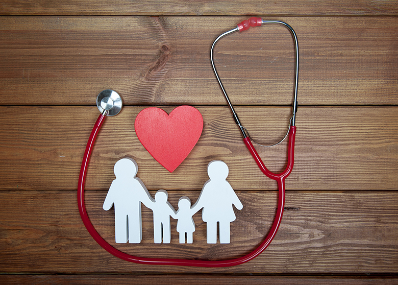 Paper cutout of family with a heart and stethoscope