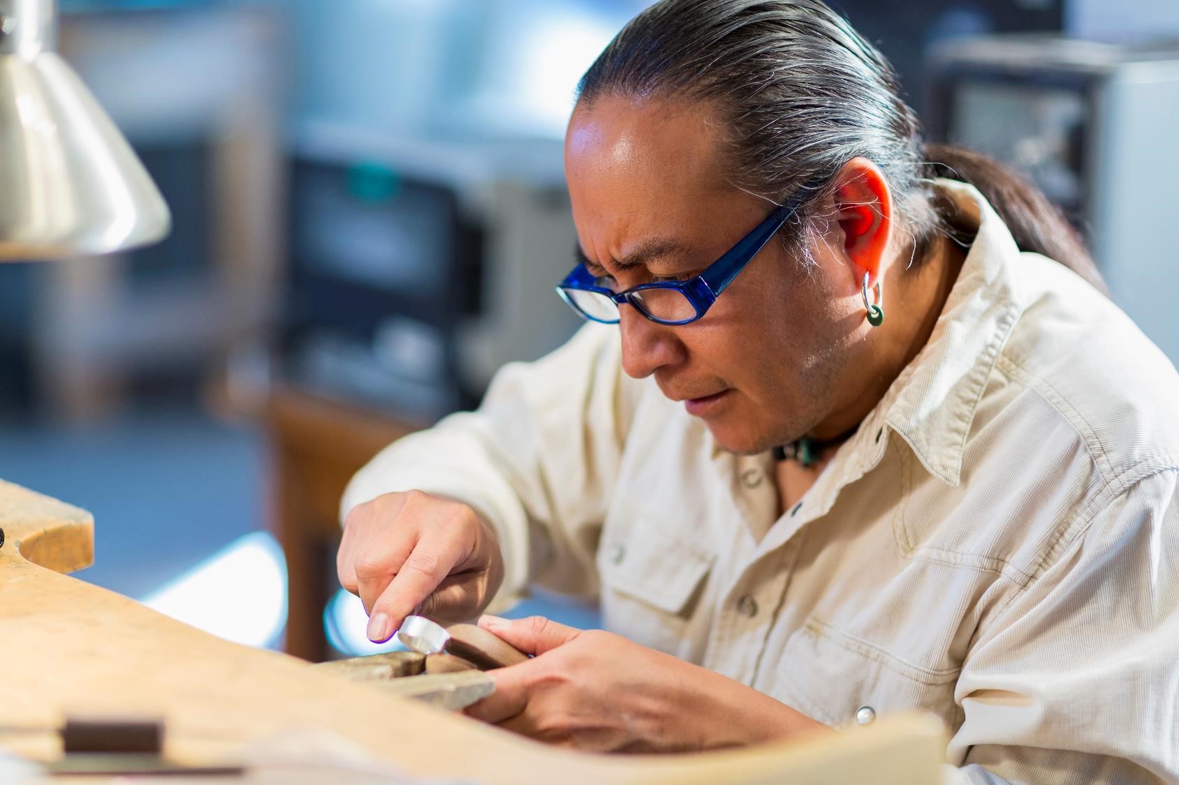 Native American man at work bench