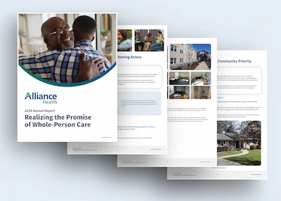 A spread of the Alliance Health Annual Report documents showcasing graphs, photos of people, and text highlights.