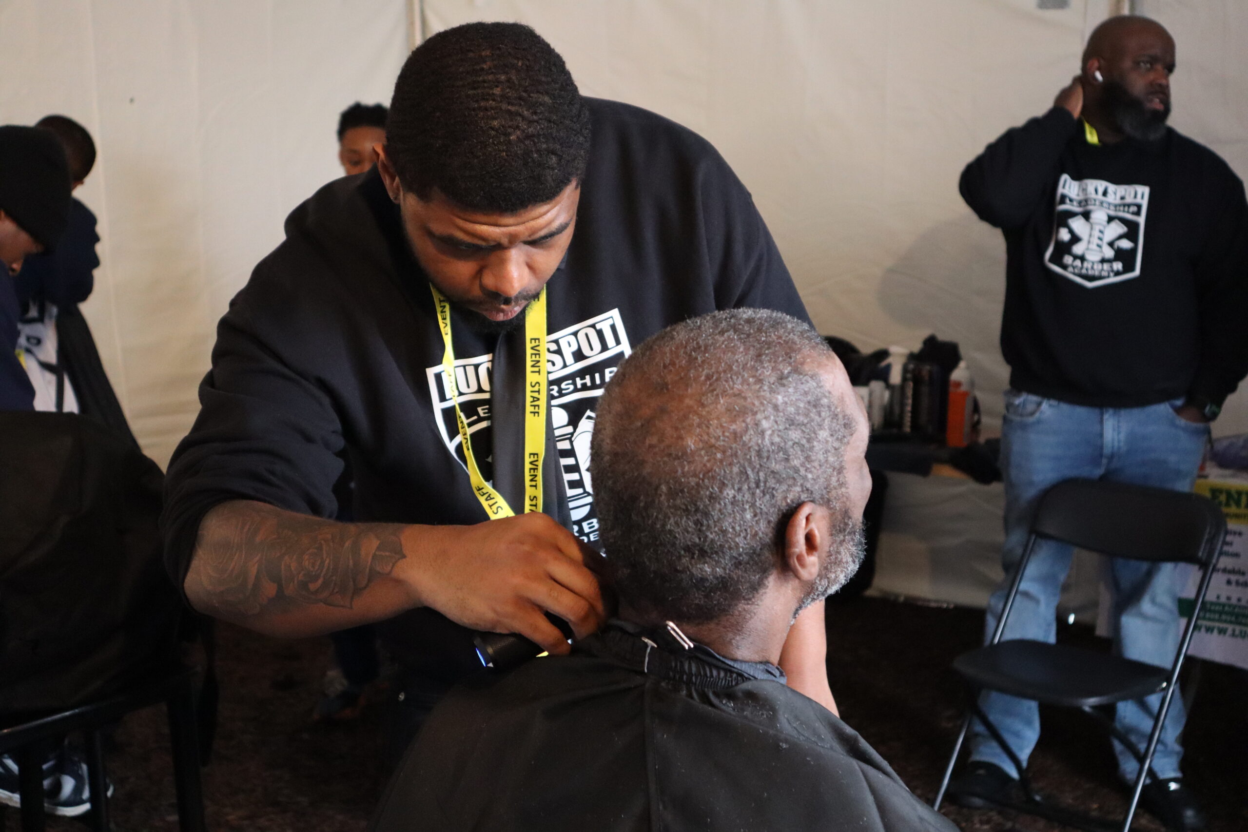 male getting his haircut by a barber